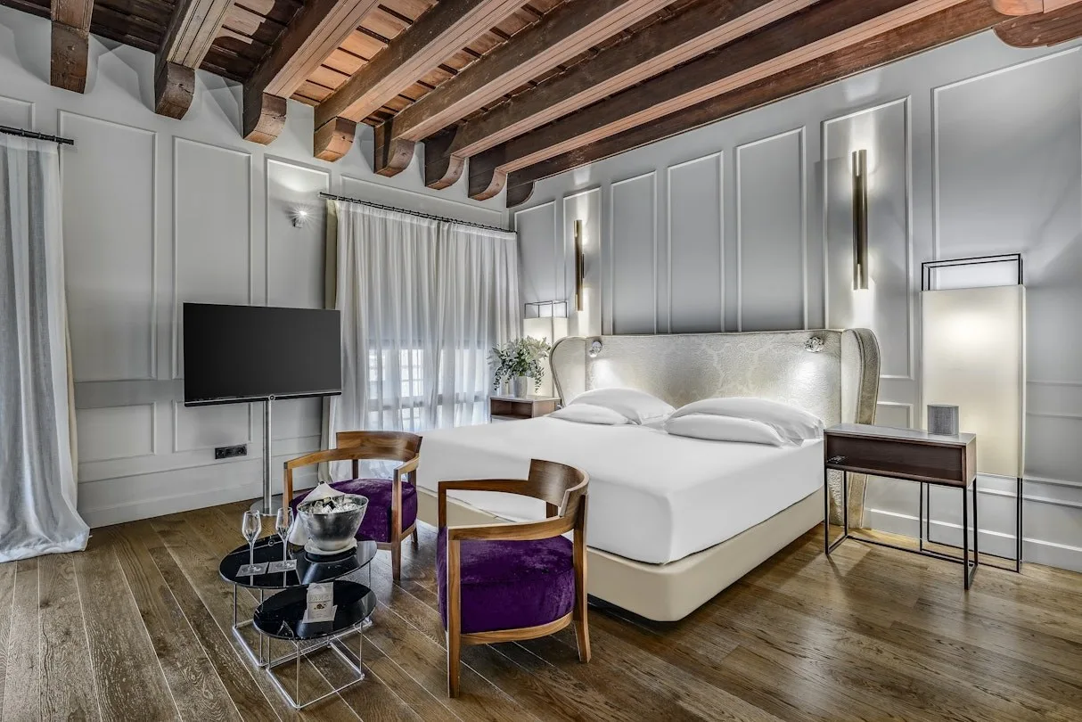 A Premium room at Palacio Villapanés — beamed ceiling, panelled walls and wide timber floorboards