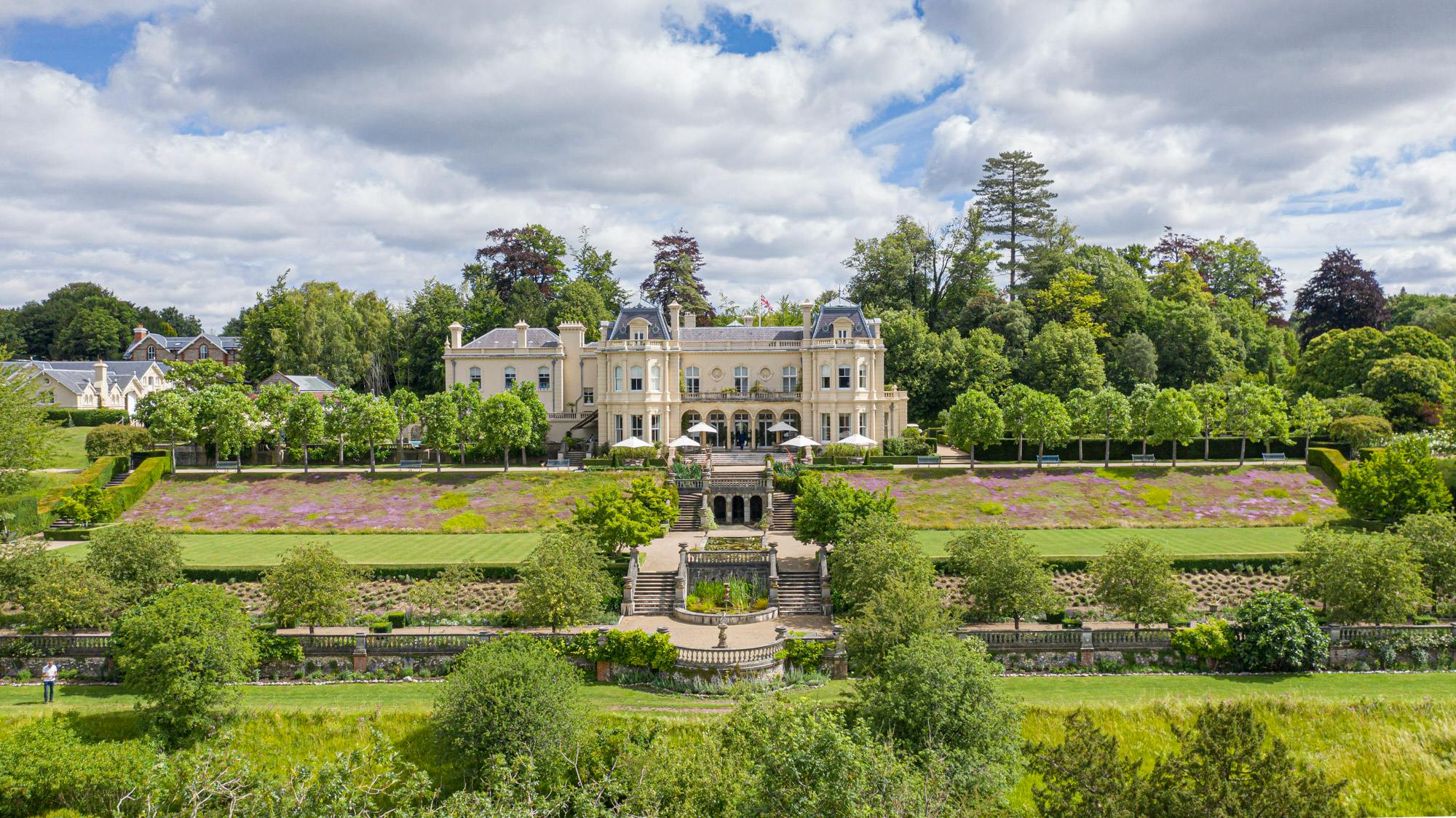 Beaverbrook — the mansion seen across its terraced gardens, lawns and clipped trees in the Surrey Hills