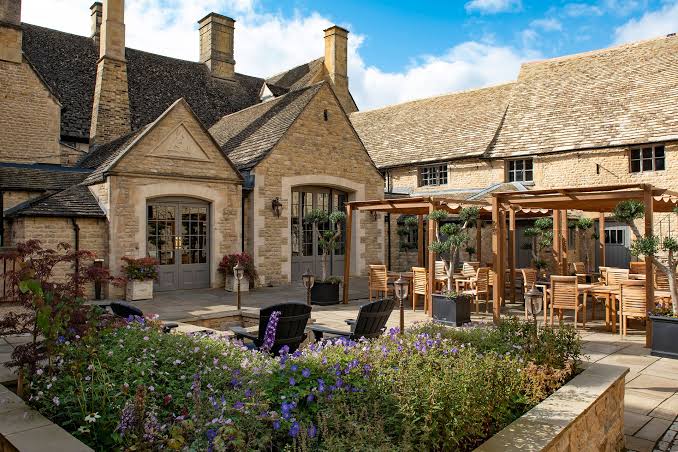 The stone courtyard and garden terrace of the historic Haycock Manor Hotel in Wansford