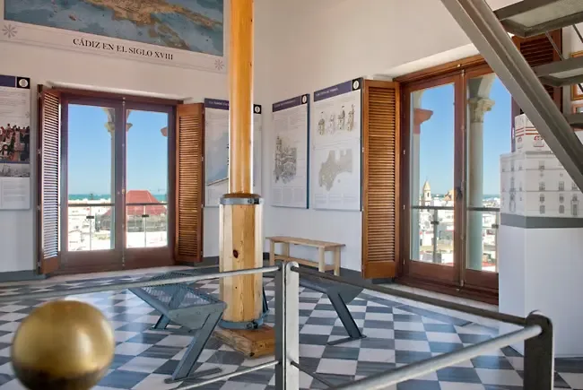 The second exhibition room at Torre Tavira, chequerboard floor and shuttered windows opening onto the rooftops of Cádiz