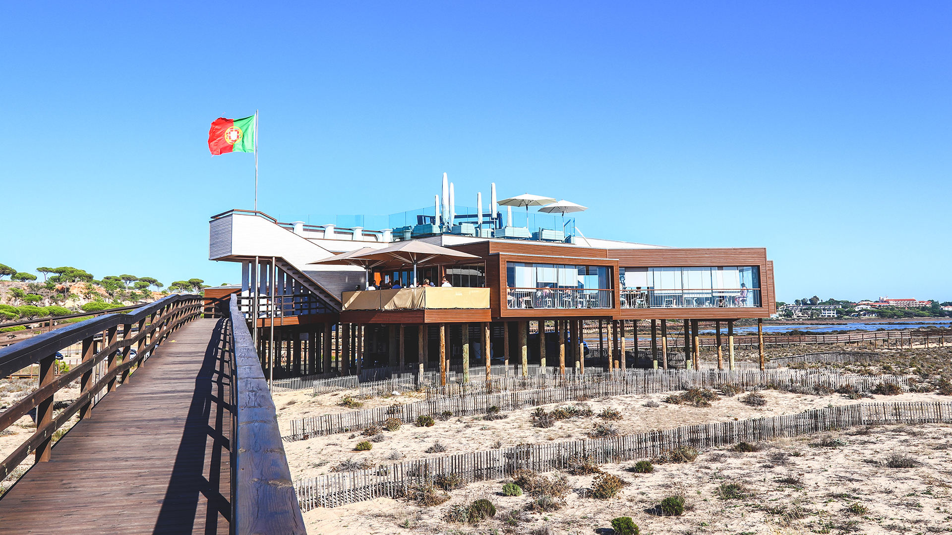 2 Passos, the timber restaurant on stilts above the dunes at Praia do Ancão, reached by a wooden walkway