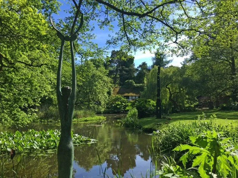 Silent Wings by Jeremy Moulsdale and Sheltering Stack by Walter Bailey on the cottage lawn above the pond