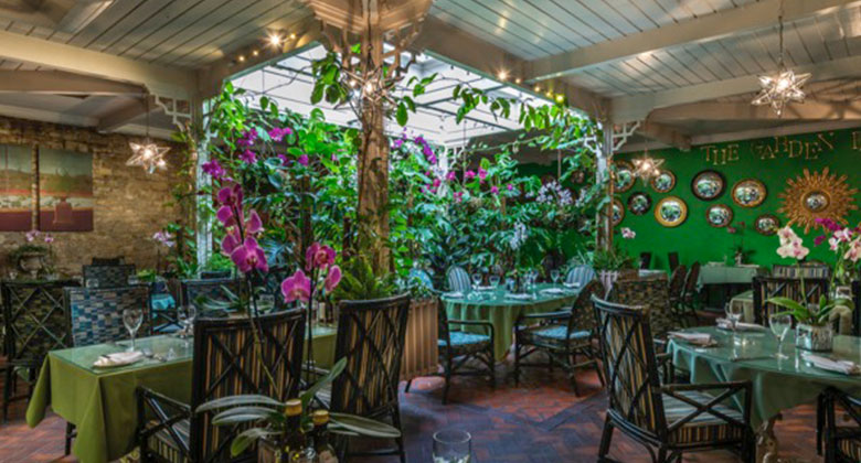 The plant-filled Garden Room restaurant at The George of Stamford