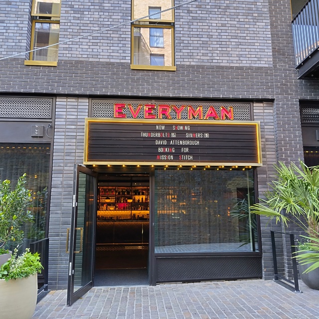 The Everyman Brentford entrance and illuminated cinema marquee in Bradbury Yard
