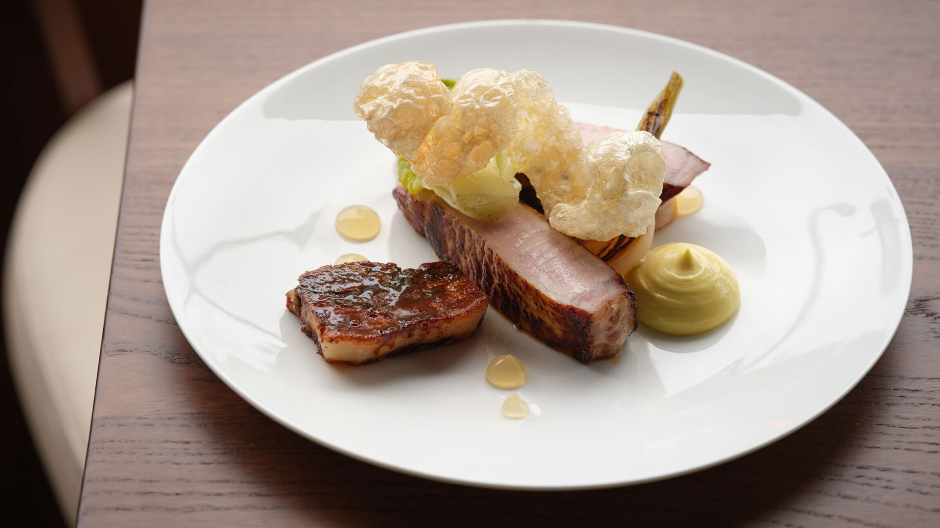 A pork main course at Starling with crackling, hispi cabbage and a quenelle of mustard sauce
