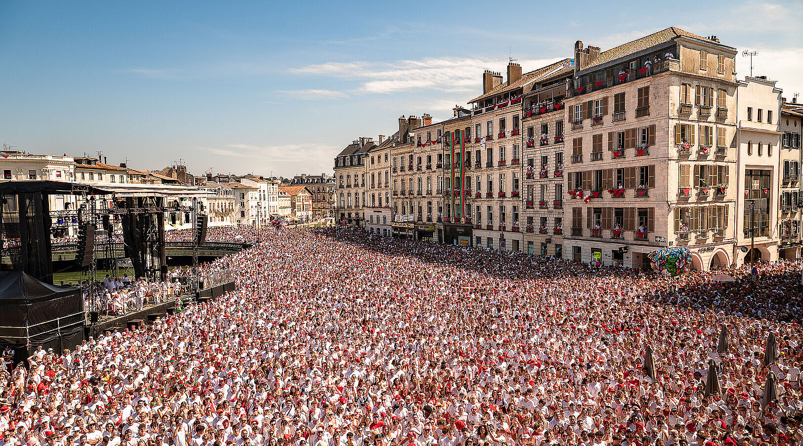 The Place de la Liberté in Bayonne filled with a vast crowd dressed in white and red at the opening of the Fêtes
