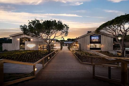 The timber walkway to the clubhouse buildings at The Campus at dusk