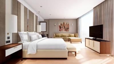 A bright bedroom at Torre Melina with pale upholstery, timber furniture and full-height windows