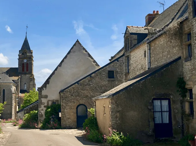 Stone houses and the church tower in the salt-working village of Saillé, Guérande