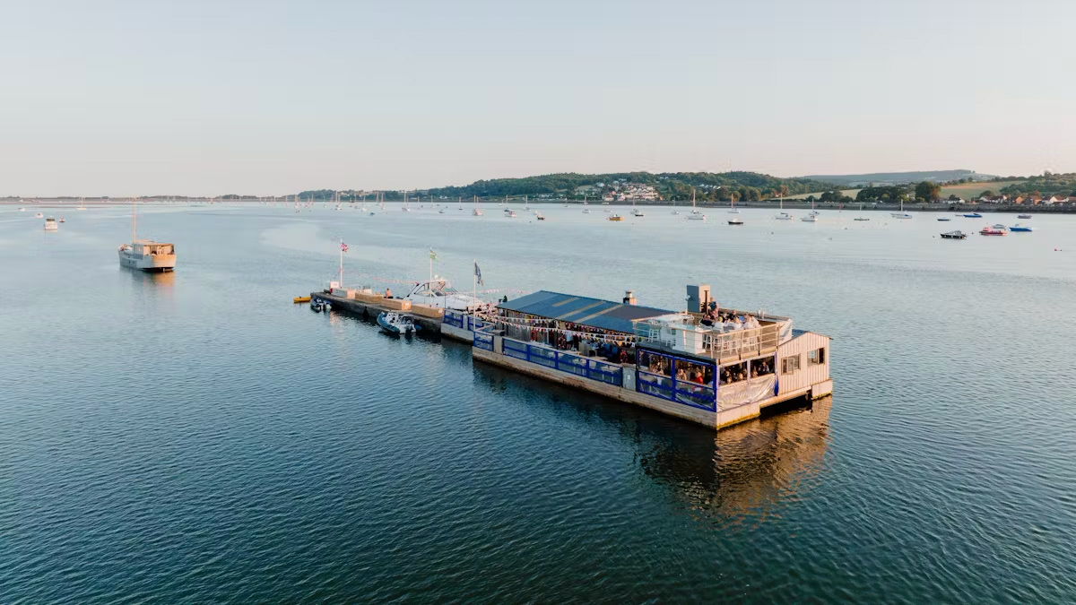 The River Exe Café, a floating barge moored on the Exe Estuary at dusk