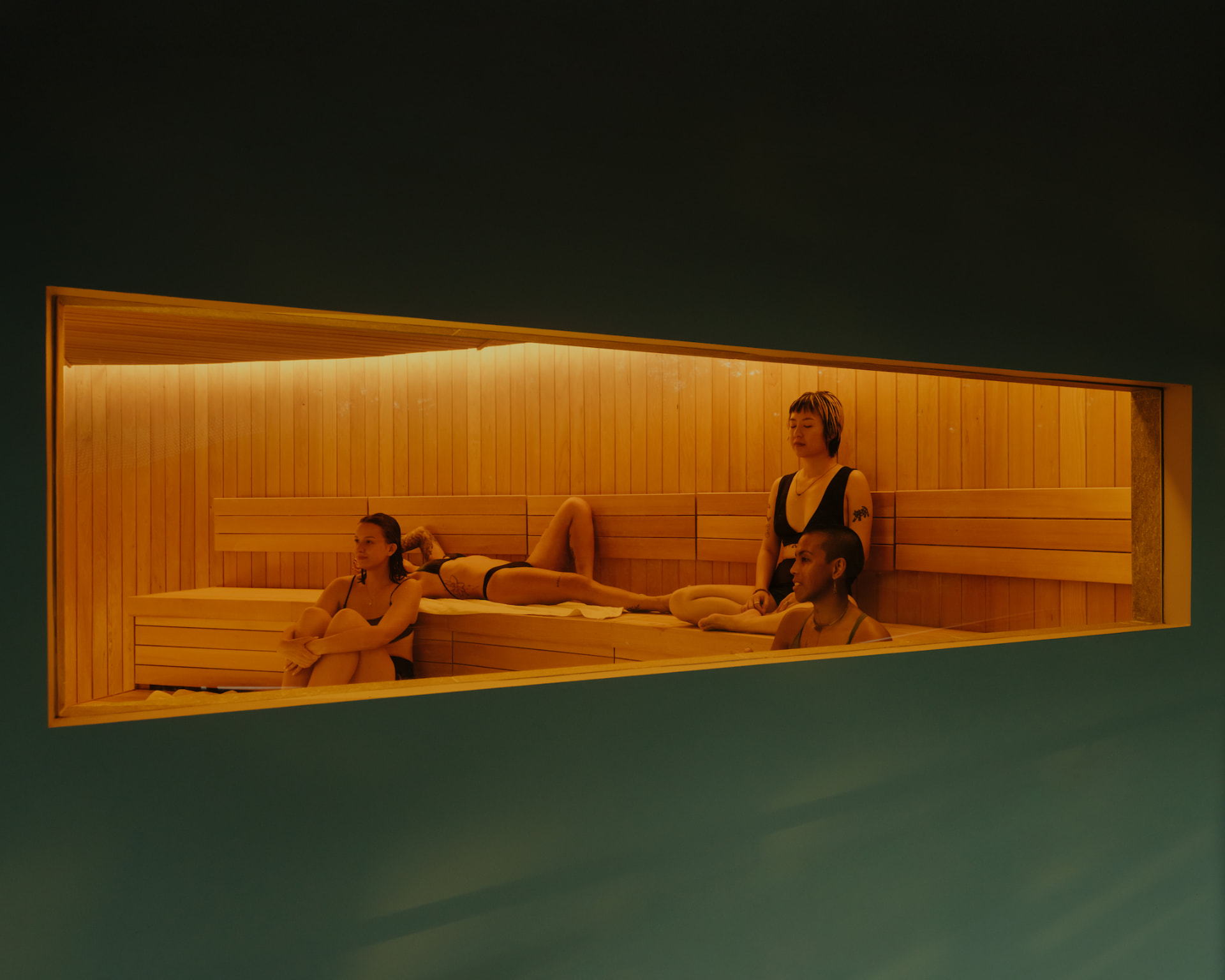 Guests resting inside the wood-lined sauna at Nowhere Baths