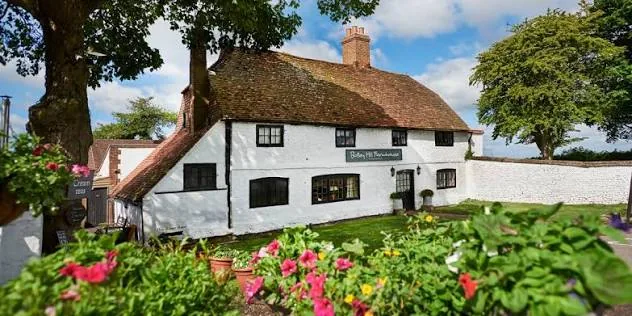 Botley Hill Farmhouse — the white-painted, timber-framed frontage of the 16th-century farmhouse on the North Downs