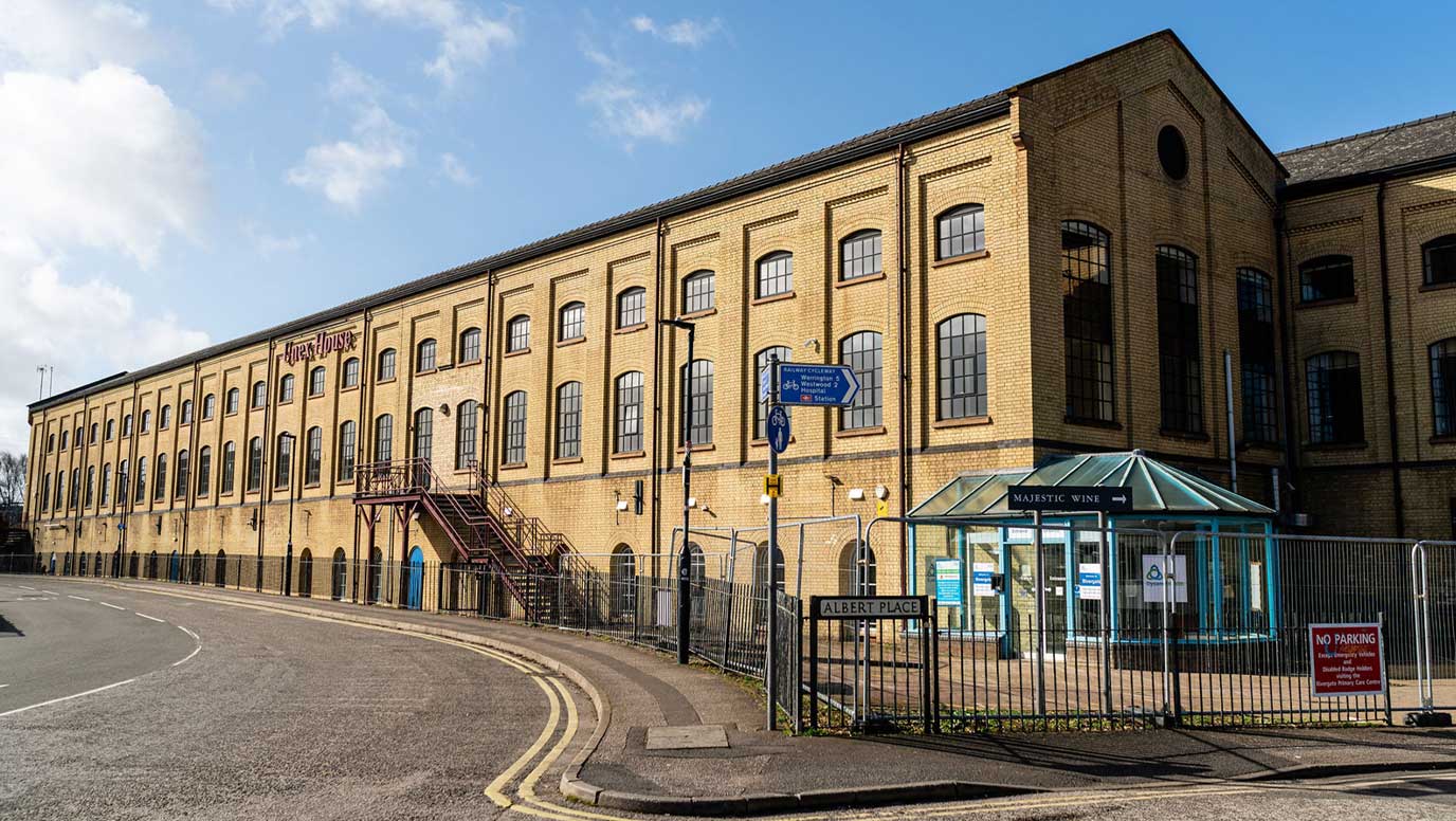 The long yellow-brick nineteenth-century railway building at Unex House, home to Old Station Quarter in Peterborough