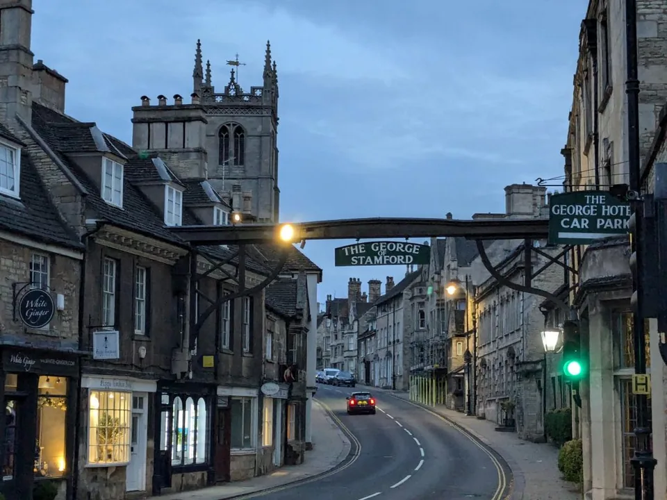 The George of Stamford gallows sign spanning the former Great North Road at dusk