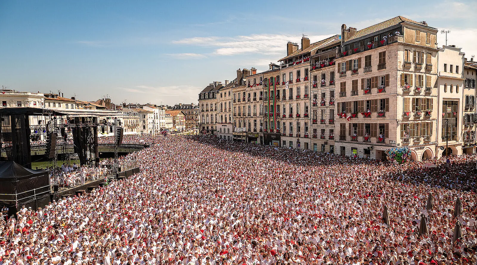 The Place de la Liberté in Bayonne filled with a vast crowd dressed in white and red at the opening of the Fêtes