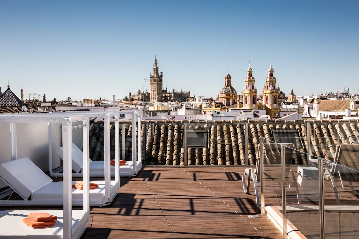 The rooftop solarium at Palacio Villapanés, looking across Seville's tiled roofs towards the Giralda